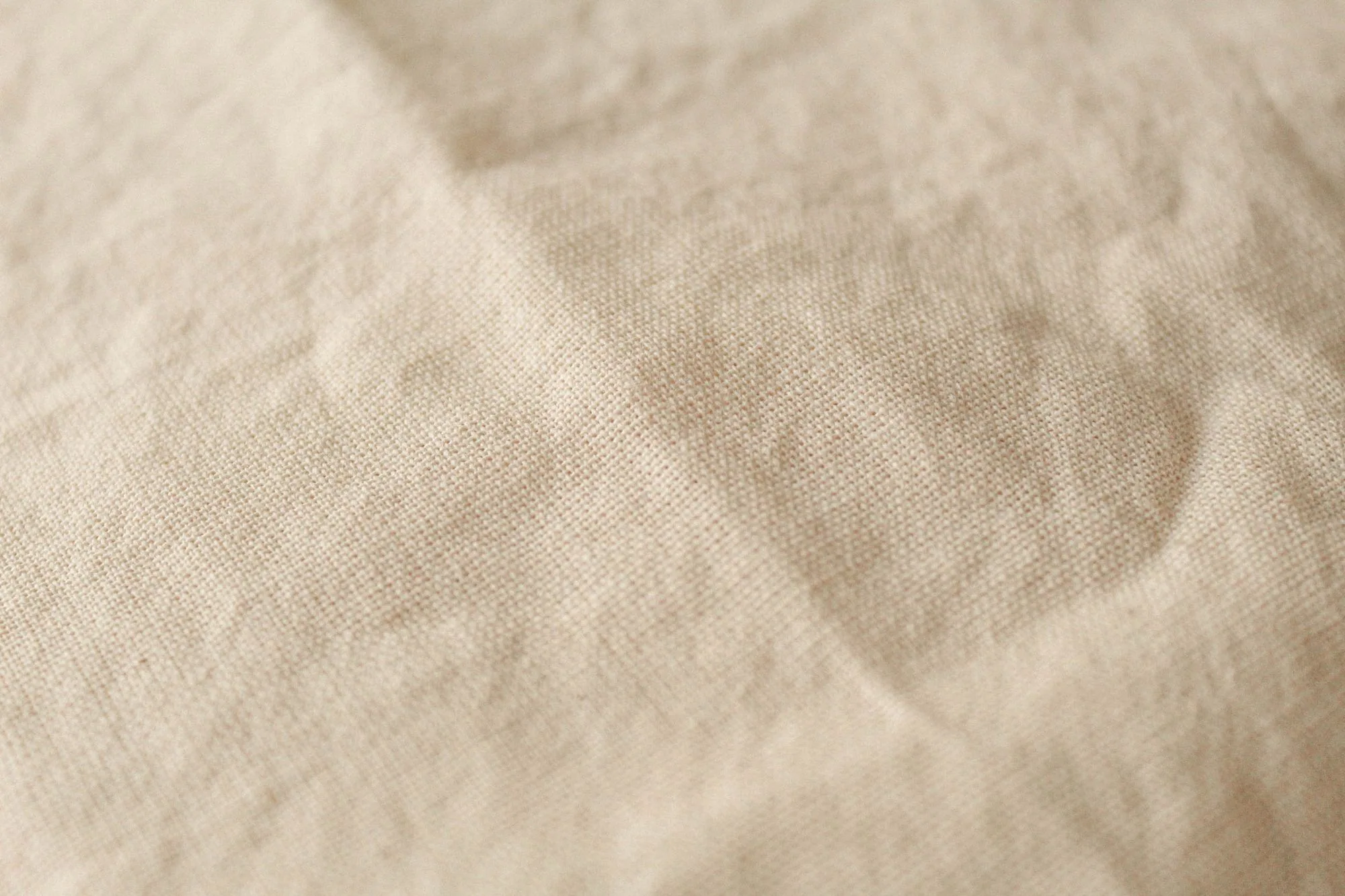 Detailed texture of beige canvas fabric with soft lighting, perfect for background or textile themes. Editorial photograph for our air conditioning guide for Dubai shoppers.
