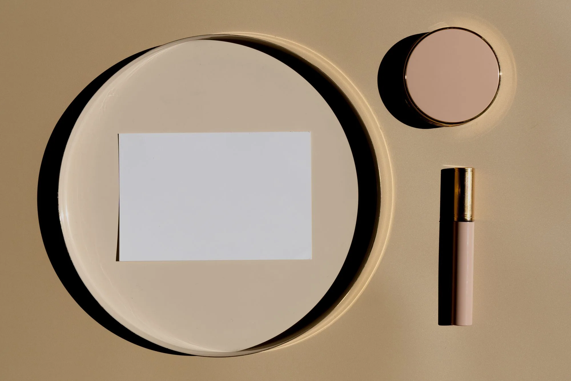 Flat lay of makeup essentials on a nude beige background, top view. Editorial photograph for our product versions guide for Dubai shoppers.